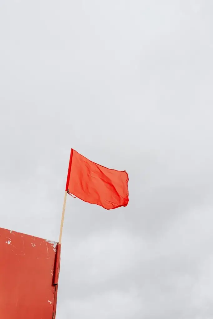 red flag on pole swaying by the wind