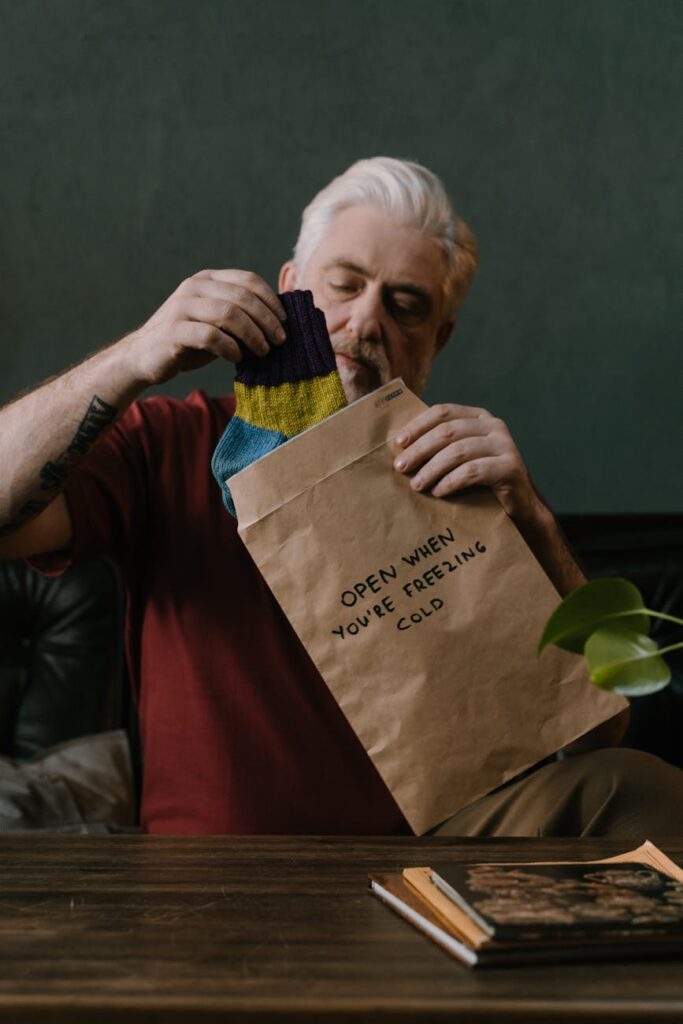 portrait of an elderly man unboxing a gift