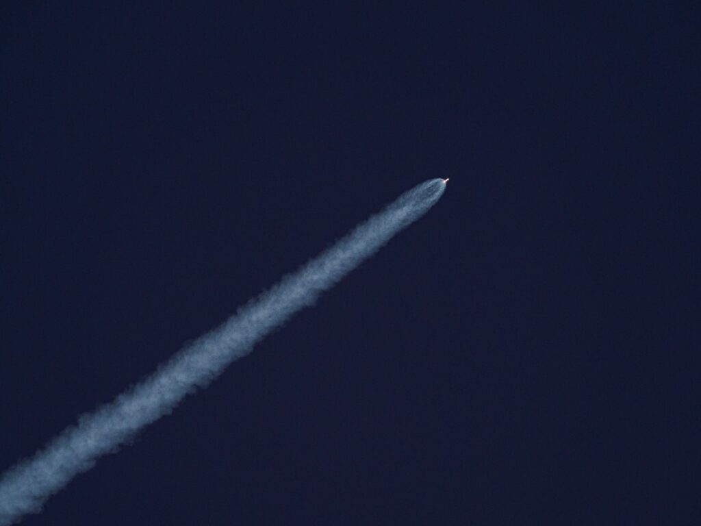 rocket launching leaving trail of smoke