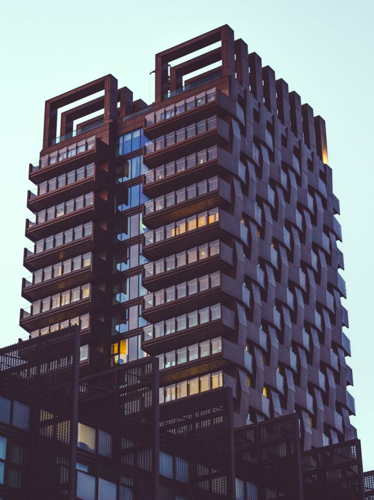 low angle photo of modern building under gloomy sky